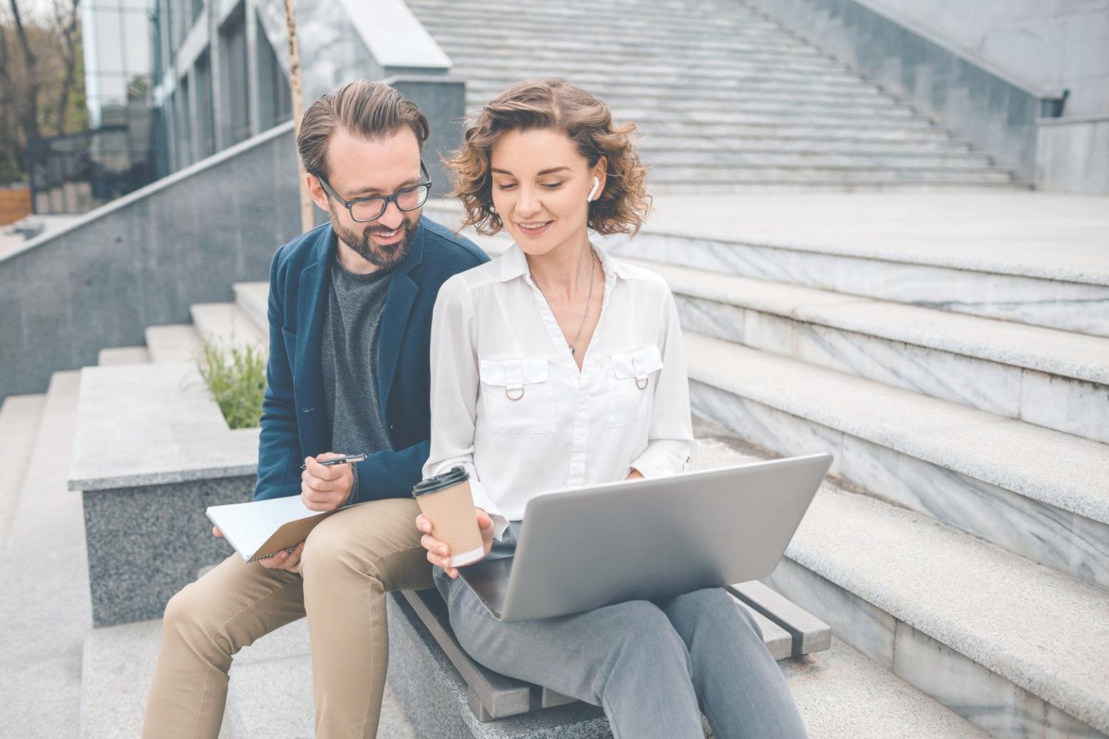 Young professional reviewing monthly expenses on laptop